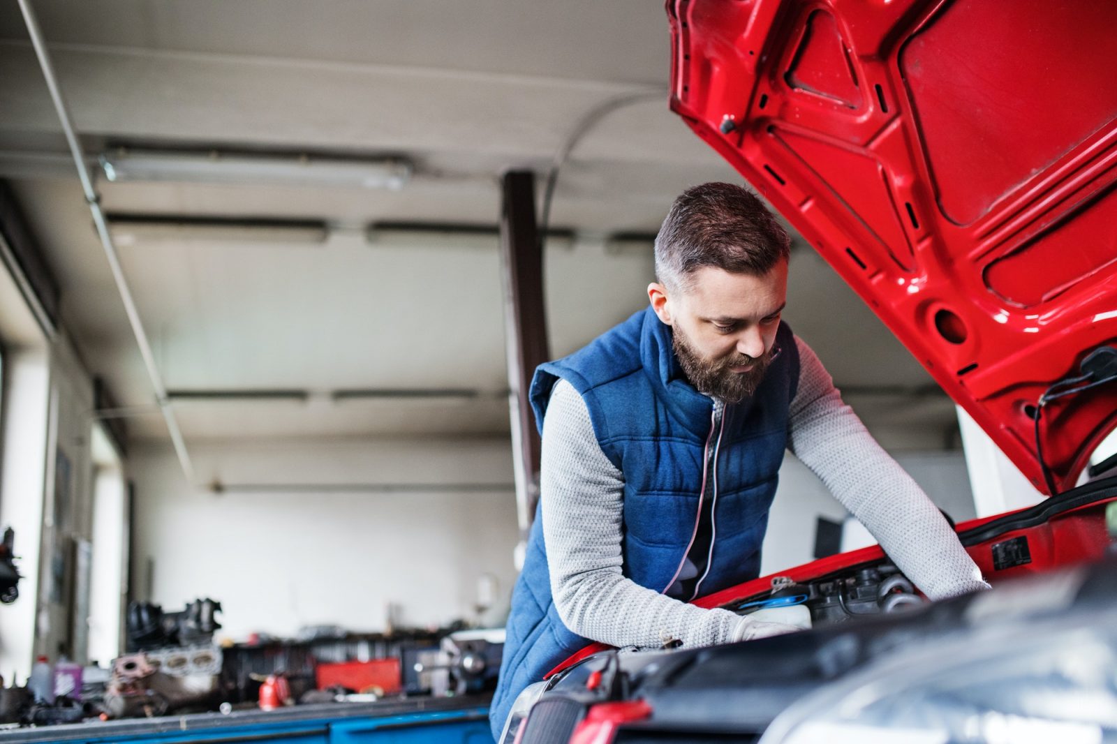 man-mechanic-repairing-a-car-in-a-garage-.jpg